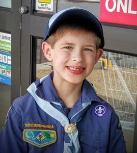 Cub Scout selling popcorn